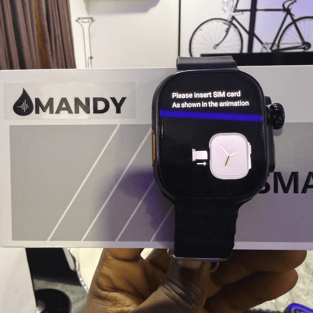 Mandy Android Smartwatch M12 with a screen displaying instructions held by a hand, with 'MANDY' branding in the background.