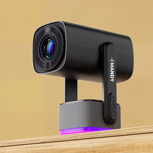 A black MANDY smart rechargeable projector with a cylindrical speaker base, resting on a wooden surface against a warm beige background.